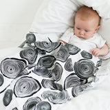 baby-looking-at-black-and-white-baby-muslin-square-plant-themed